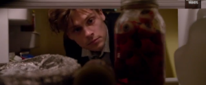 Reid examines Garcias fridge and finds suspicious eyeball jar.